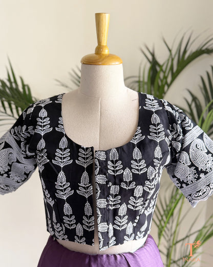 Ethnic blouse with all-over Chikankari embroidery and decorative sleeve buttons.
