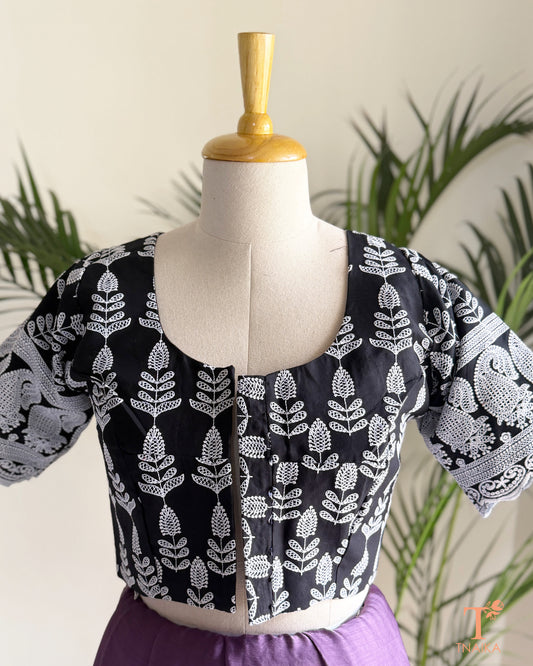 Ethnic blouse with all-over Chikankari embroidery and decorative sleeve buttons.