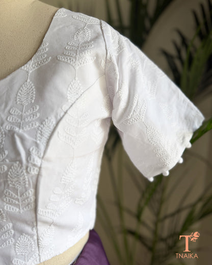 Elegant saree blouse with all-over Chikankari embroidery and decorative potli buttons.