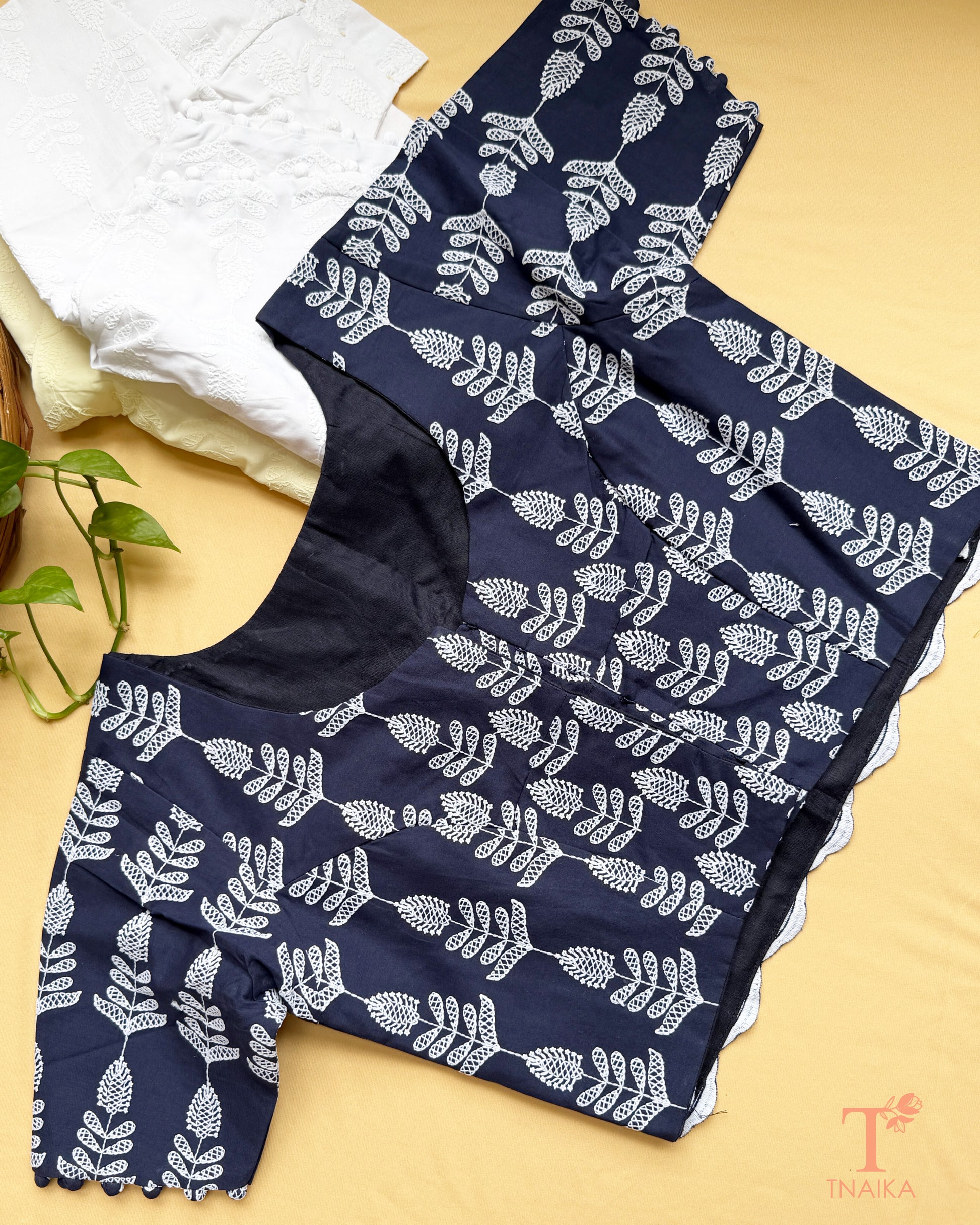 Elegant saree blouse with all-over Chikankari embroidery and decorative potli buttons.