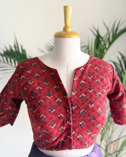 Ajrakh hand block print Hakoba cotton readymade blouse with embroidered eyelet fabric and V-notch neckline.