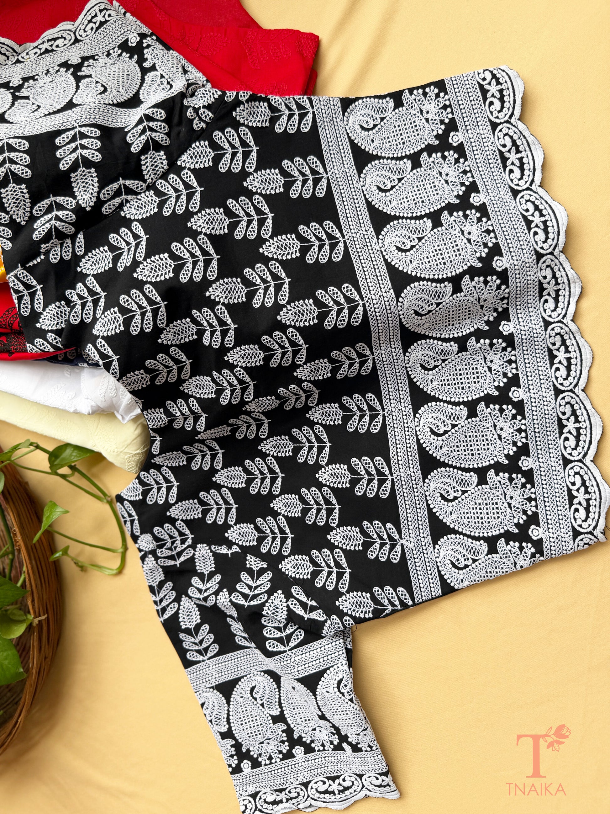 Traditional embroidered blouse with Chikankari-inspired thread work and elbow-length sleeves.