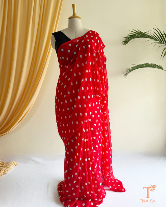 Elegant georgette saree designed with timeless polka dots.
