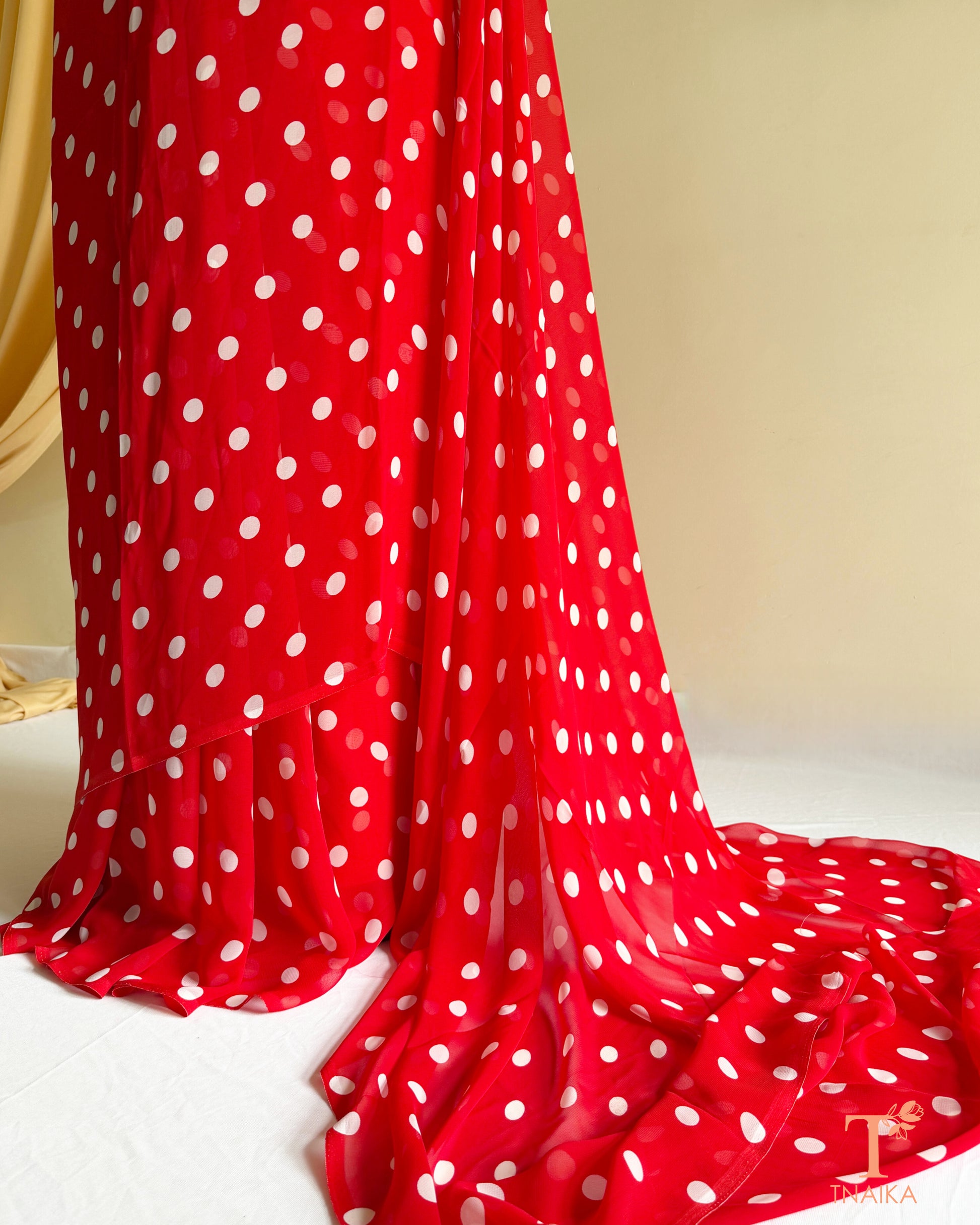 Contemporary georgette saree with stylish dot pattern.