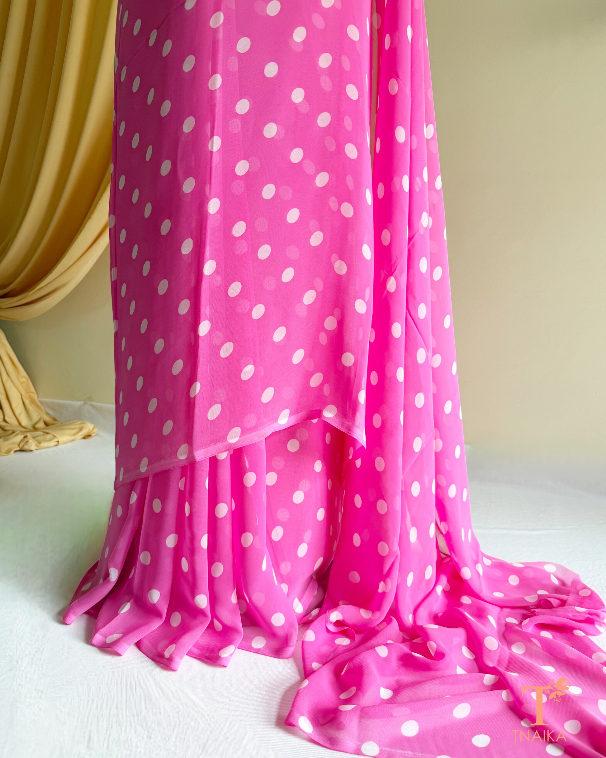 Soft flowing georgette saree with minimal polka print.