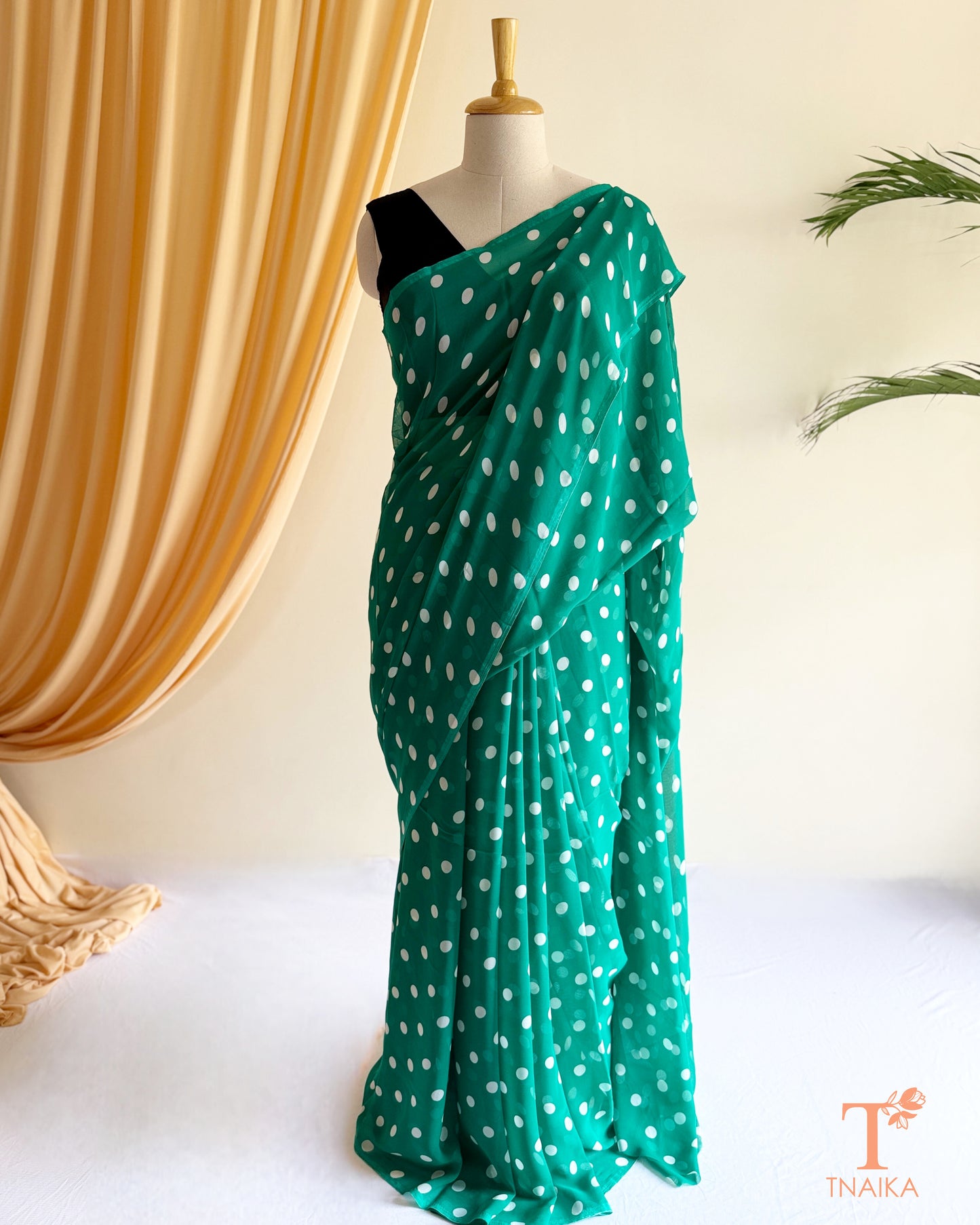 Soft flowing georgette saree with minimal polka print.