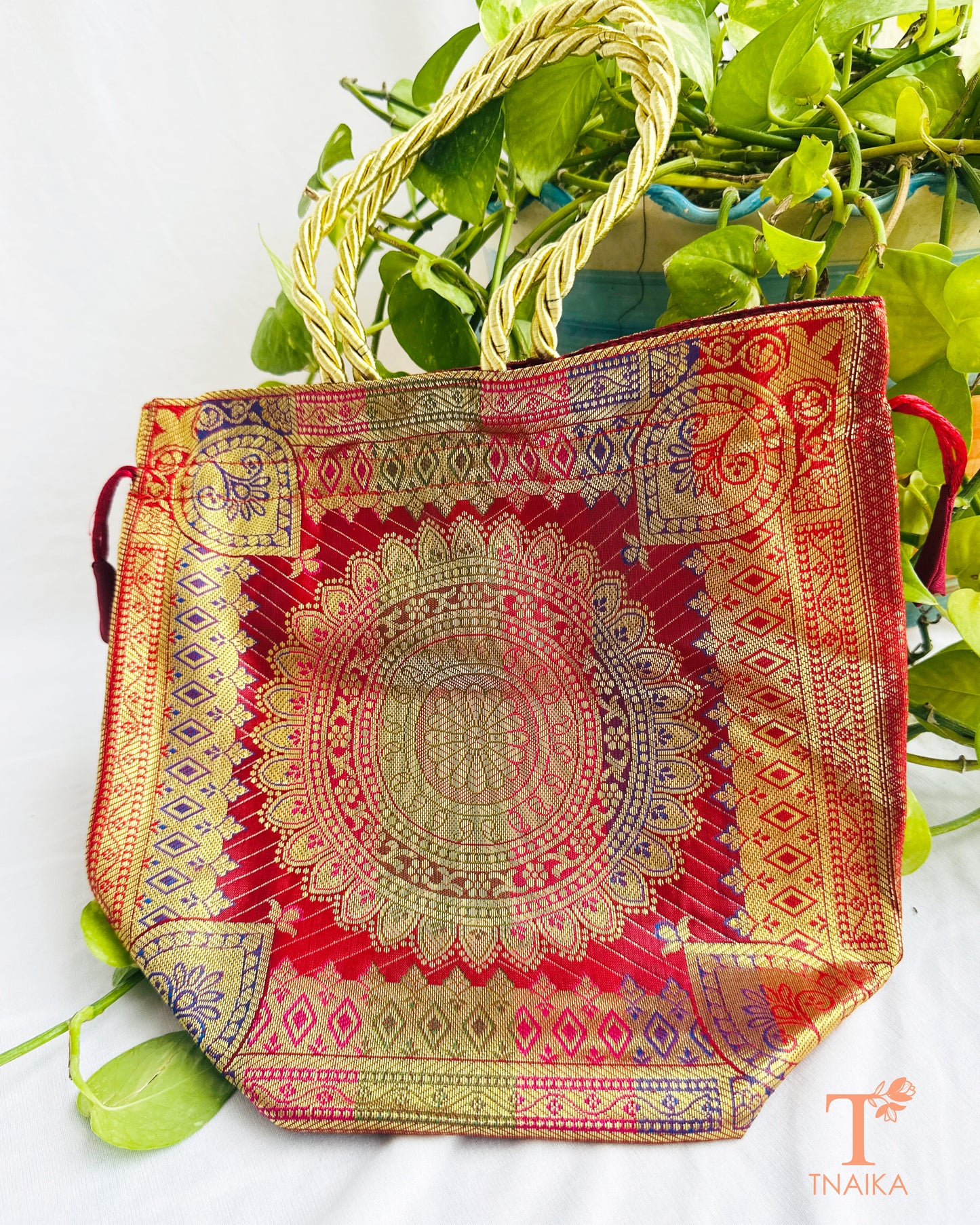 Traditional Banarasi woven fabric convertible handbag featuring dual styling as a tote bag or drawstring potli with rope handles.