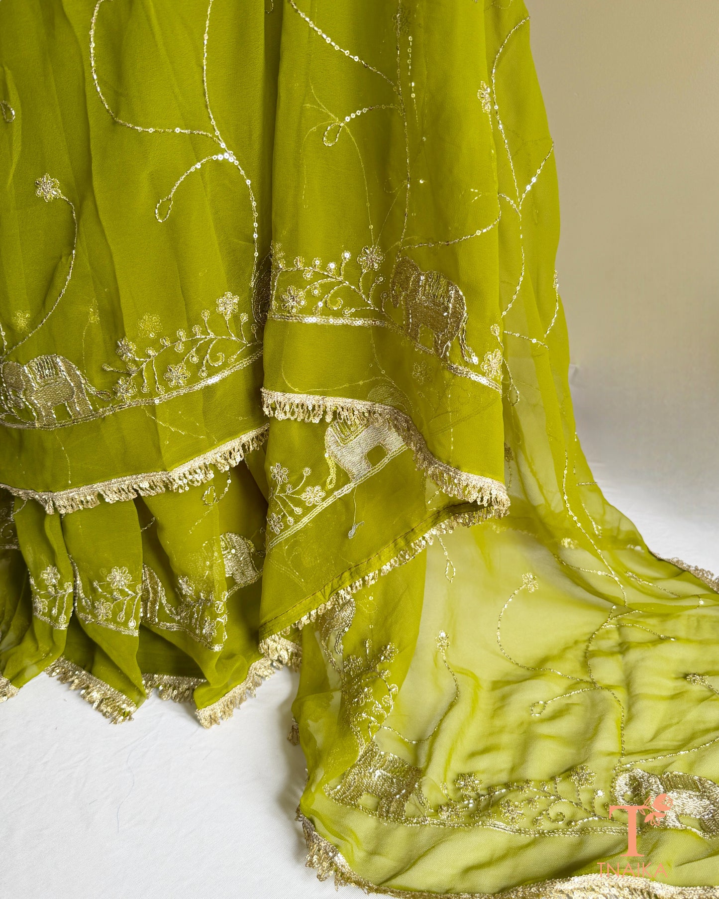 Lightweight georgette saree featuring embroidered elephant border and lace detailing