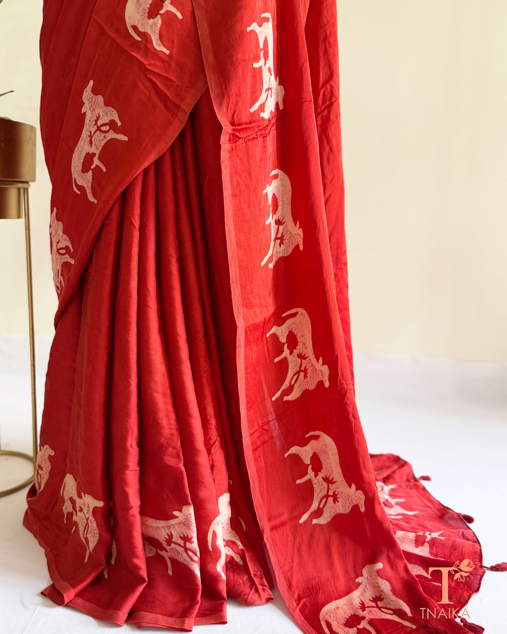Handcrafted modal saree featuring detailed cow motifs and natural artistry