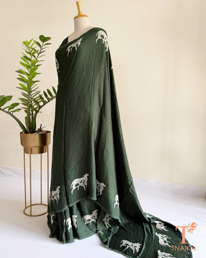 Handcrafted modal saree featuring detailed cow motifs and natural artistry