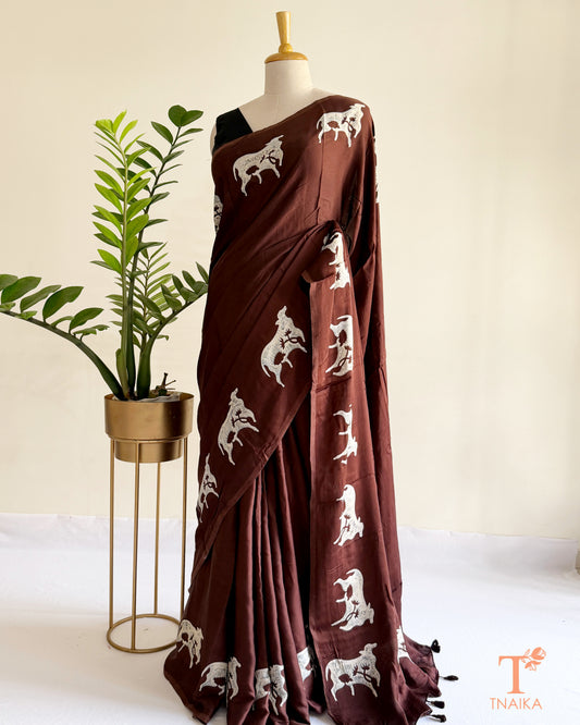 Hand-dyed modal silk saree featuring handcrafted cow motifs
