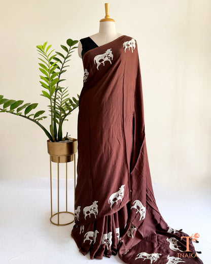 Handcrafted modal saree featuring detailed cow motifs and natural artistry