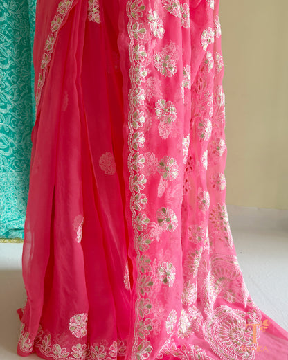 Pink chiffon saree with embroidered floral motifs and embellished pallu