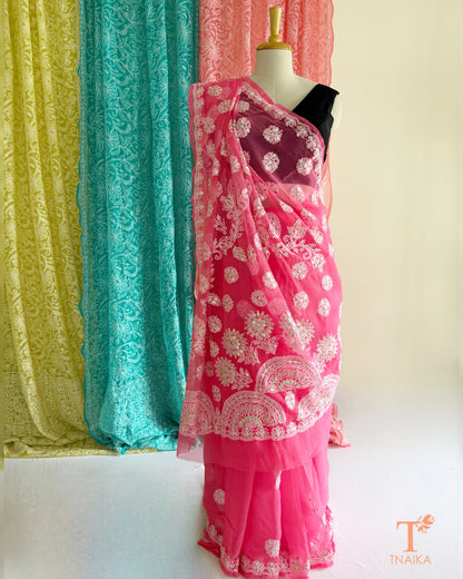 Festive pink Chikankari saree with intricate Gotta Patti embroidery and floral border