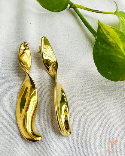 Pair of long gold-tone sculptural earrings showing their smooth curved shape and push-back fastening.