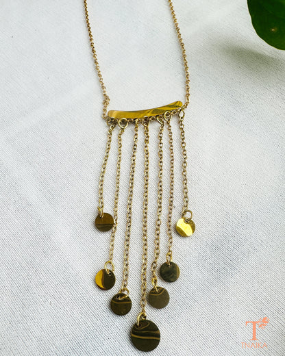 Minimal gold tone necklace with cascading chains and round hanging details for everyday and occasion wear.