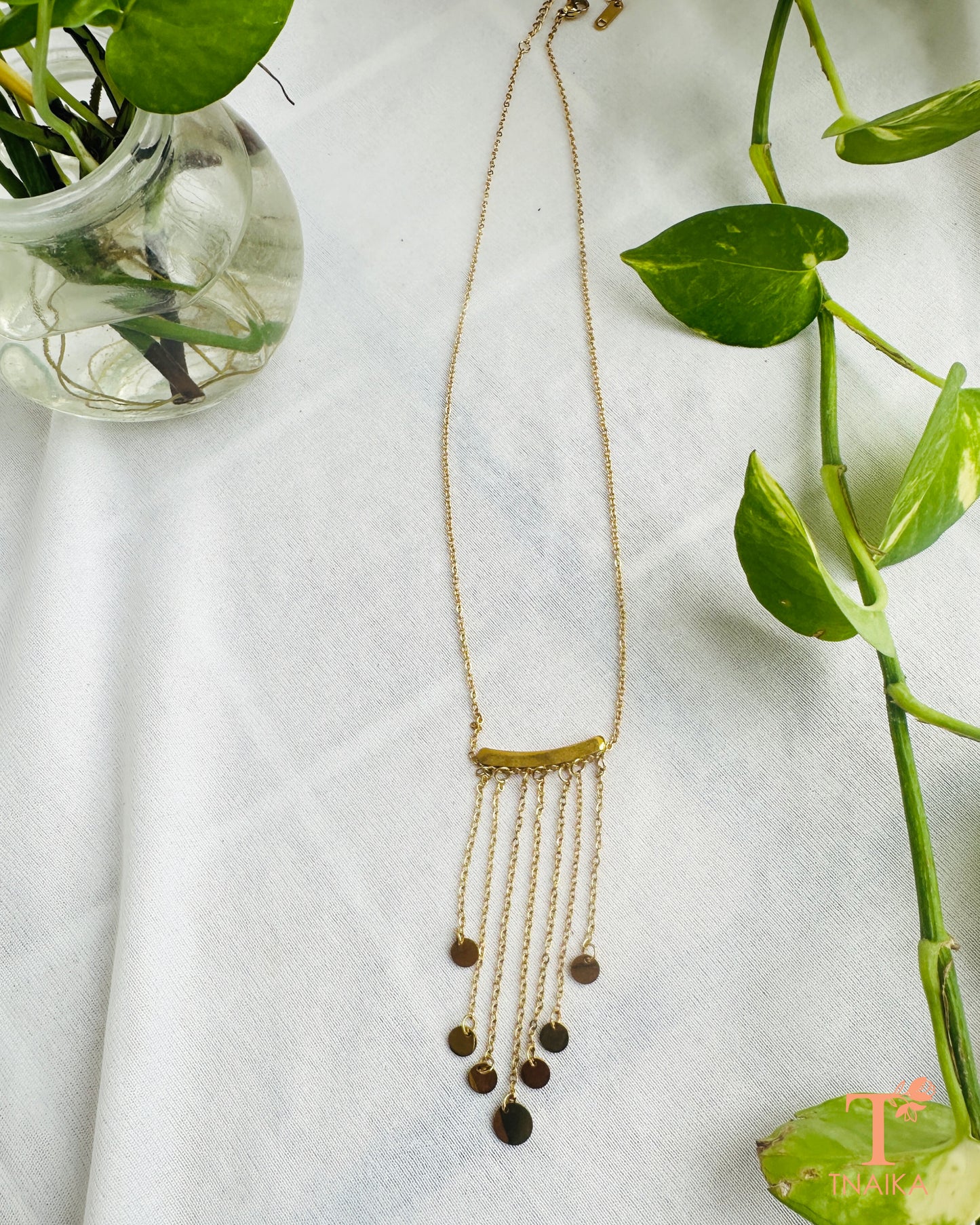 Anti-tarnish layered chain necklace for women featuring a curved bar design and delicate dangling charms.