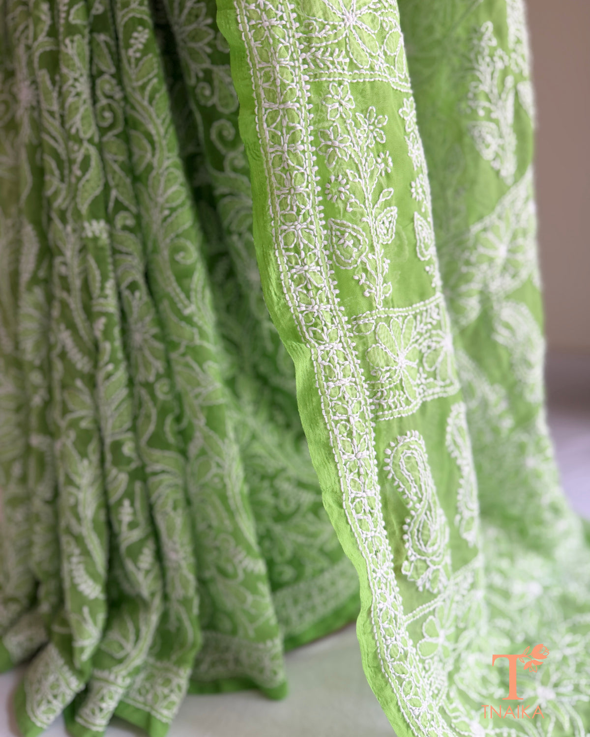 Elegant green chikankari saree with intricate all-over jaal work and floral motifs