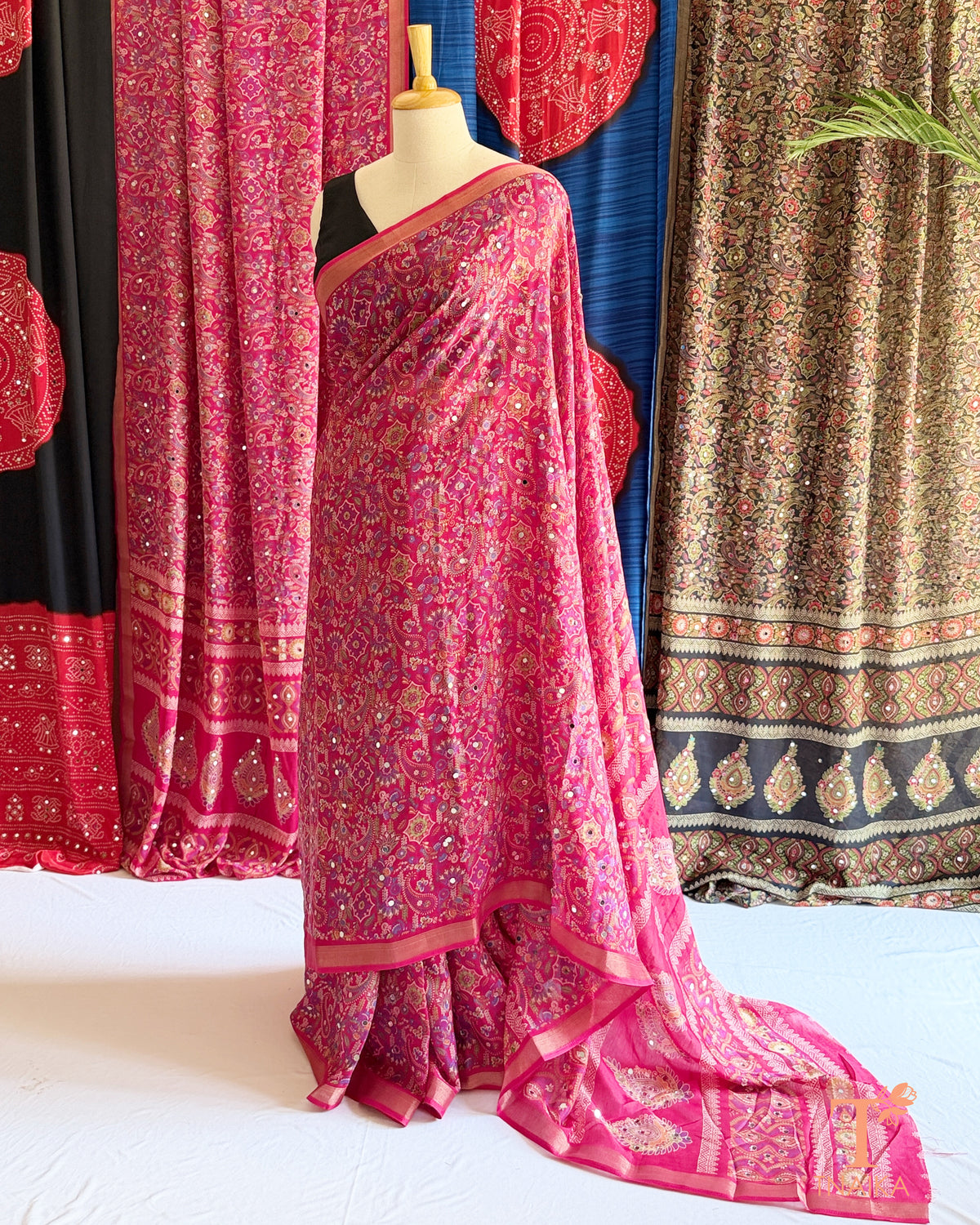 Pink printed saree with mirror embellishments and decorative border
