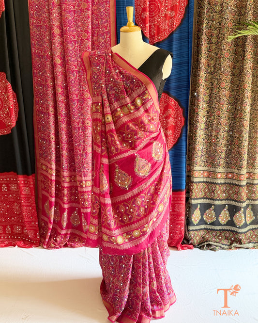 Festive pink saree with printed patterns and detailed pallu