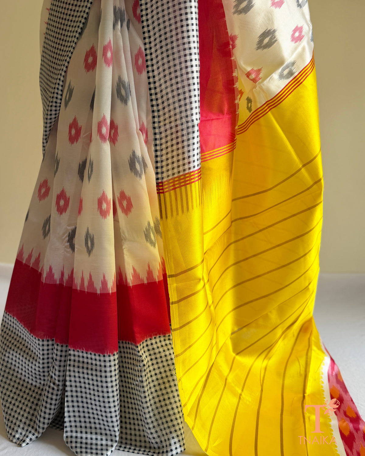 Satin silk saree with tribal-inspired prints, striped design, and bold navy teal border detailing