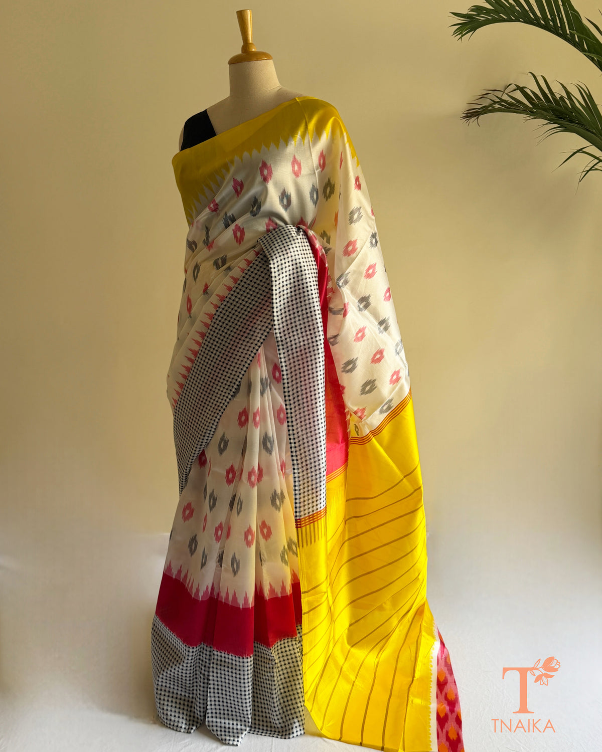Contemporary satin silk saree featuring abstract motifs, smooth drape, and elegant striped pallu