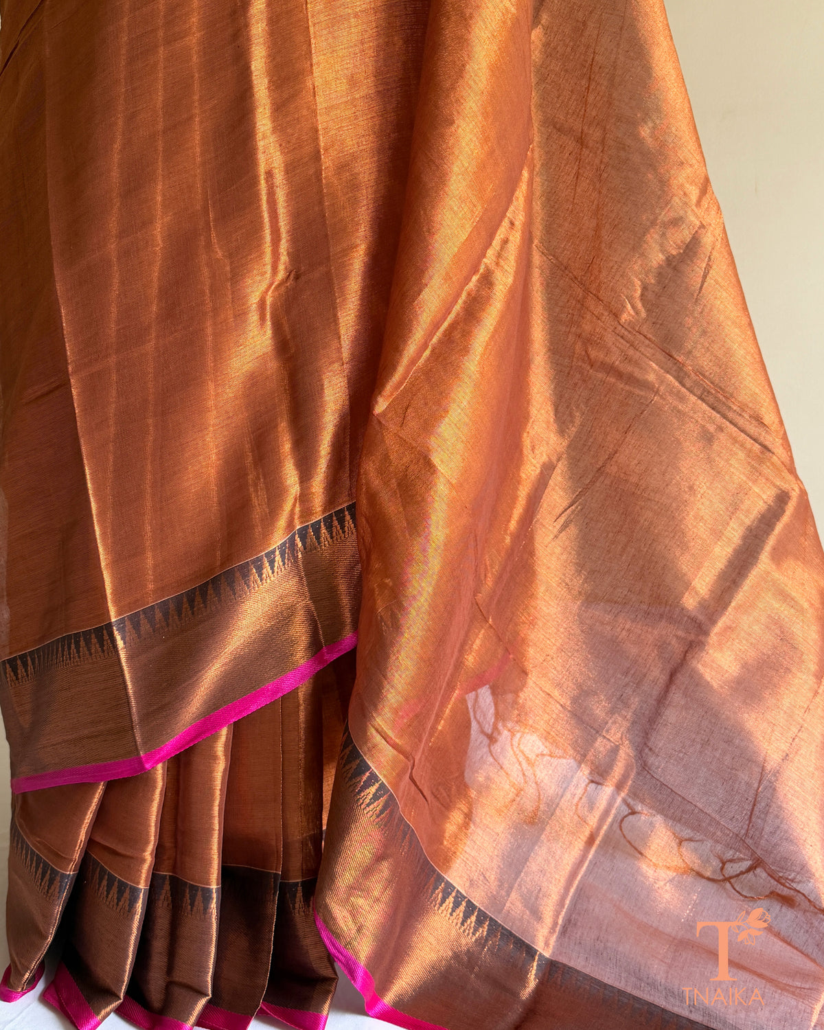 Tissue silk saree featuring a shimmering finish and elegant border