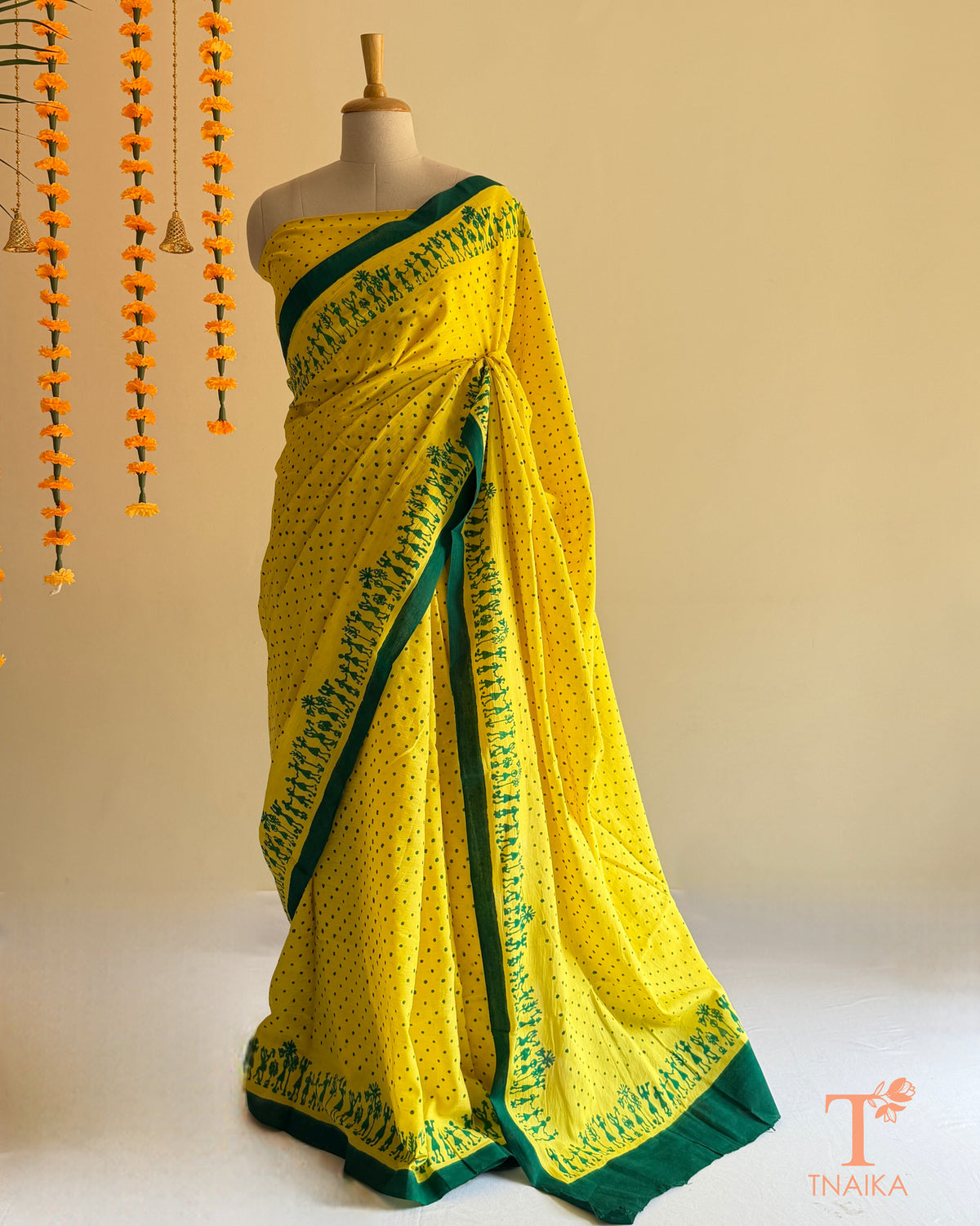 Yellow Mul cotton saree with green Warli-inspired printed border