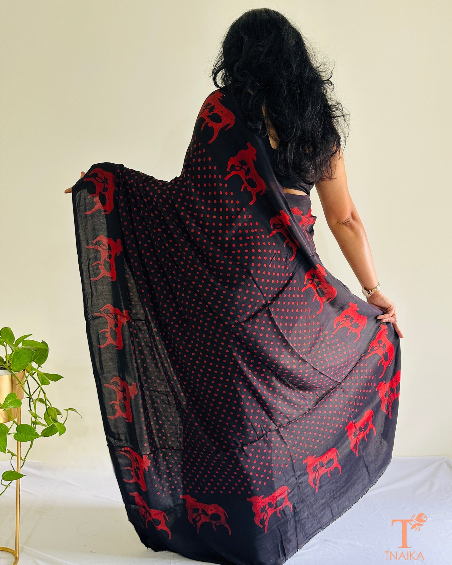 Lightweight black modal silk saree with cultural cow design