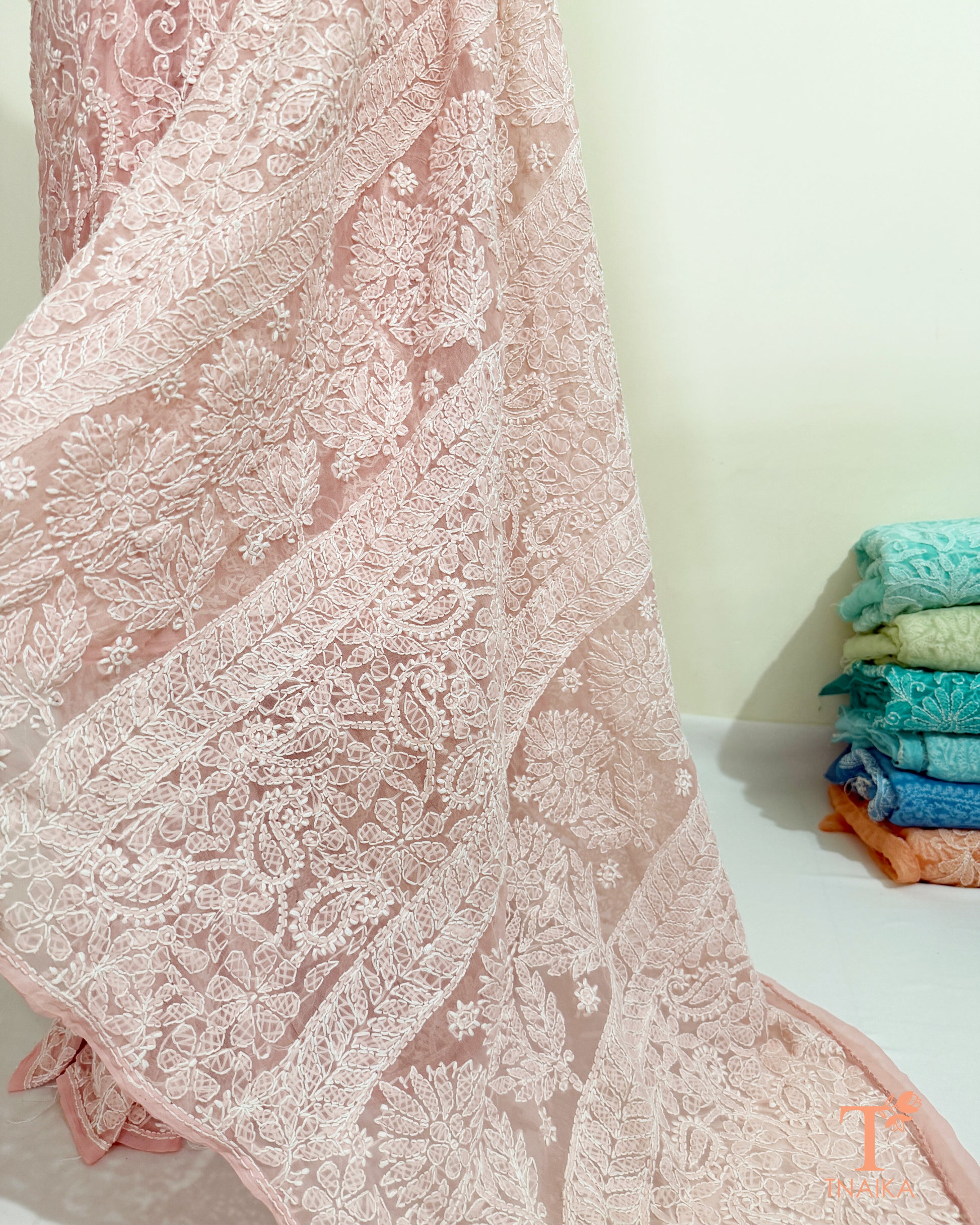 Lightweight blush pink Chikankari saree with handcrafted floral and paisley embroidery.