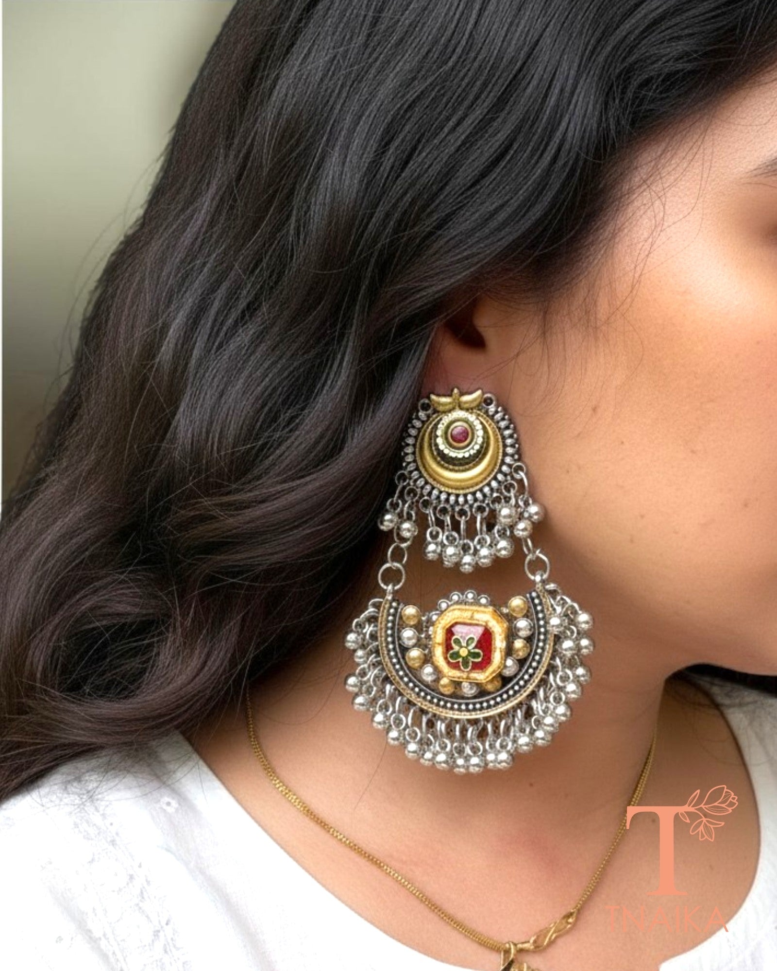 Traditional silver replica statement earrings featuring colorful meena motifs and ghungroos.