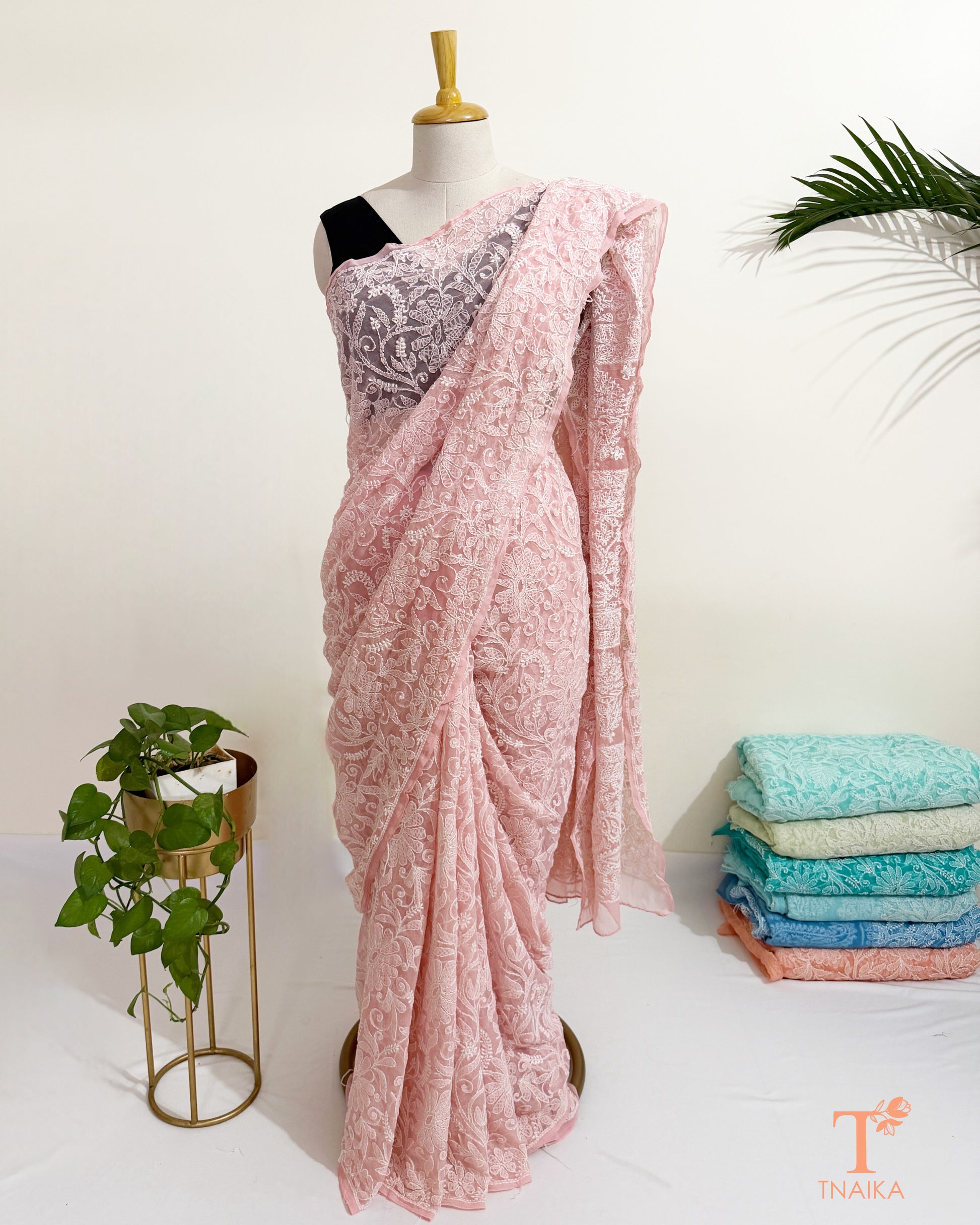 Full jaal embroidered blush pink saree with detailed Chikankari pallu and border.