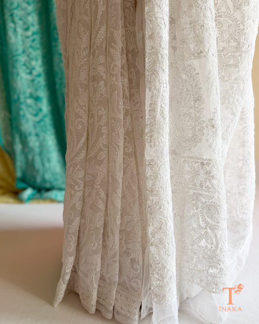 Elegant Chikankari saree with all-over white floral embroidery and delicate handcrafted detailing.