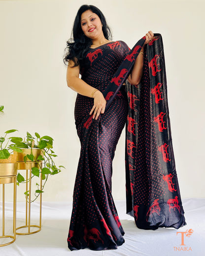 Hand-printed cow motif border on black modal silk saree