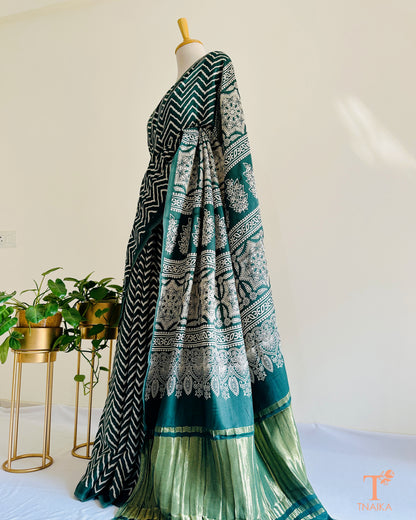 Modal silk leheriya saree with tissue lagadi patta pallu and Ajrakh detailing, paired with unstitched bandhani running blouse.