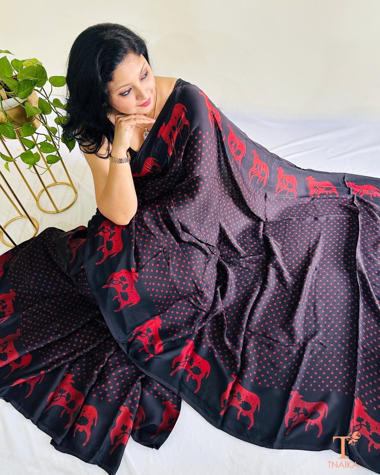 Custom black modal silk saree featuring Indian cow design on border
