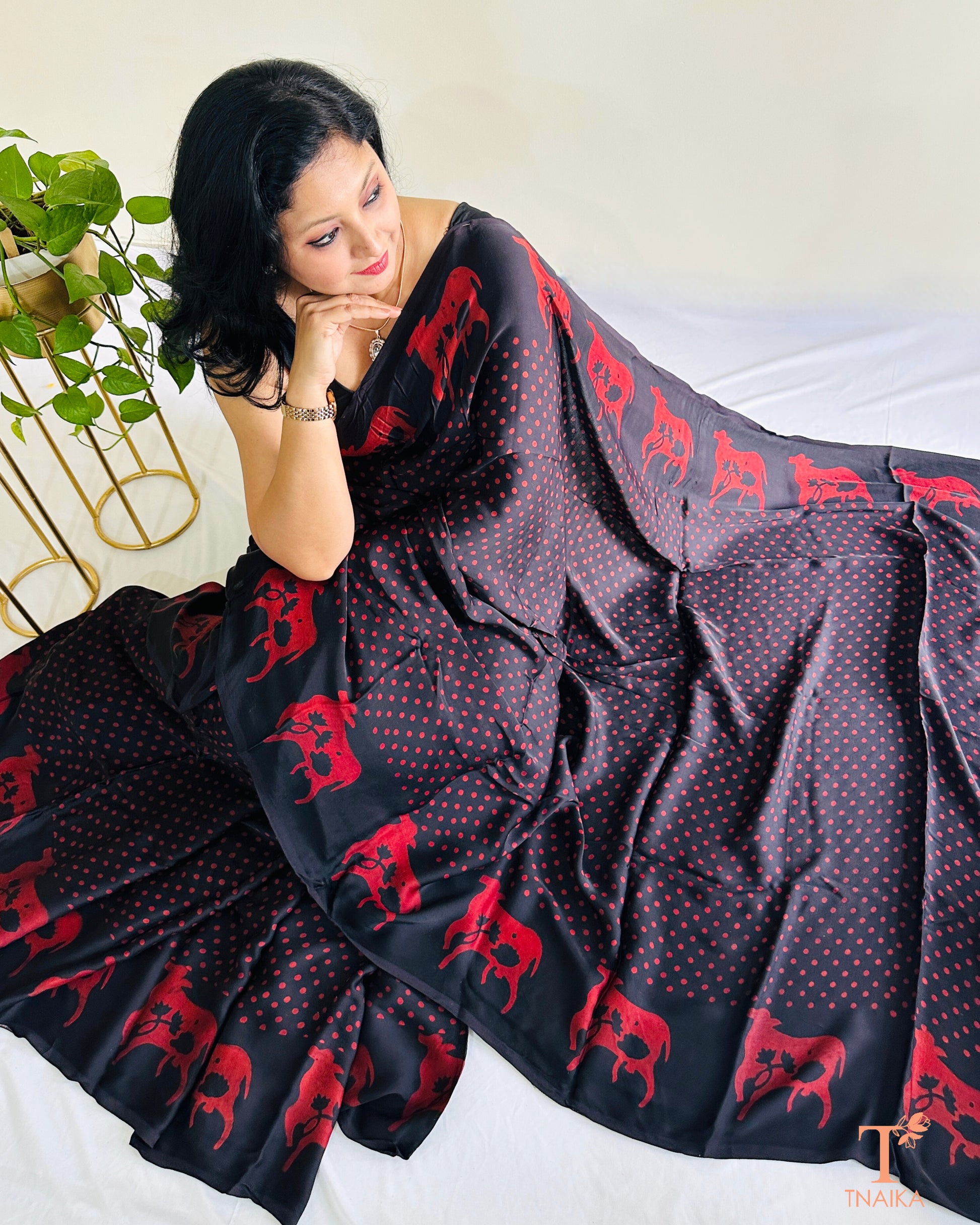 Custom black modal silk saree featuring Indian cow design on border