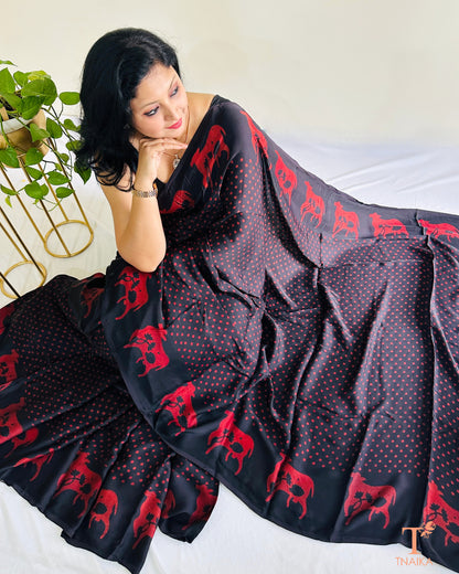 Custom black modal silk saree featuring Indian cow design on border